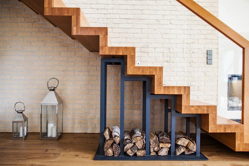 modern_solution_to_storage_pile_of_wood_under_the_stairs_at_home