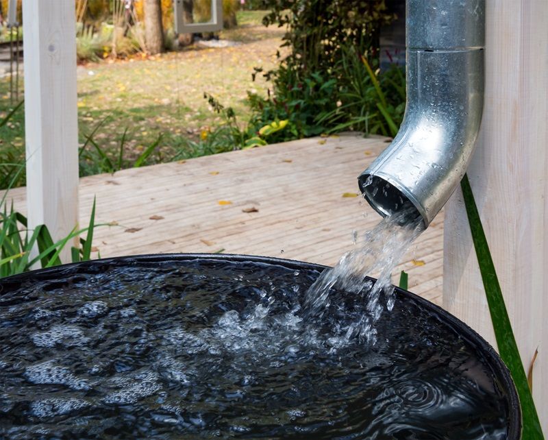 Water_drains_from_the_drain_pipe_into_a_metal_container