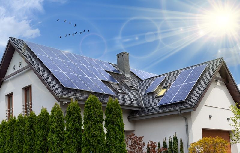 Solar_panels_on_a_gable_roof._Beautiful,_large_modern_house_and_solar_energy._Rays_of_the_sun.